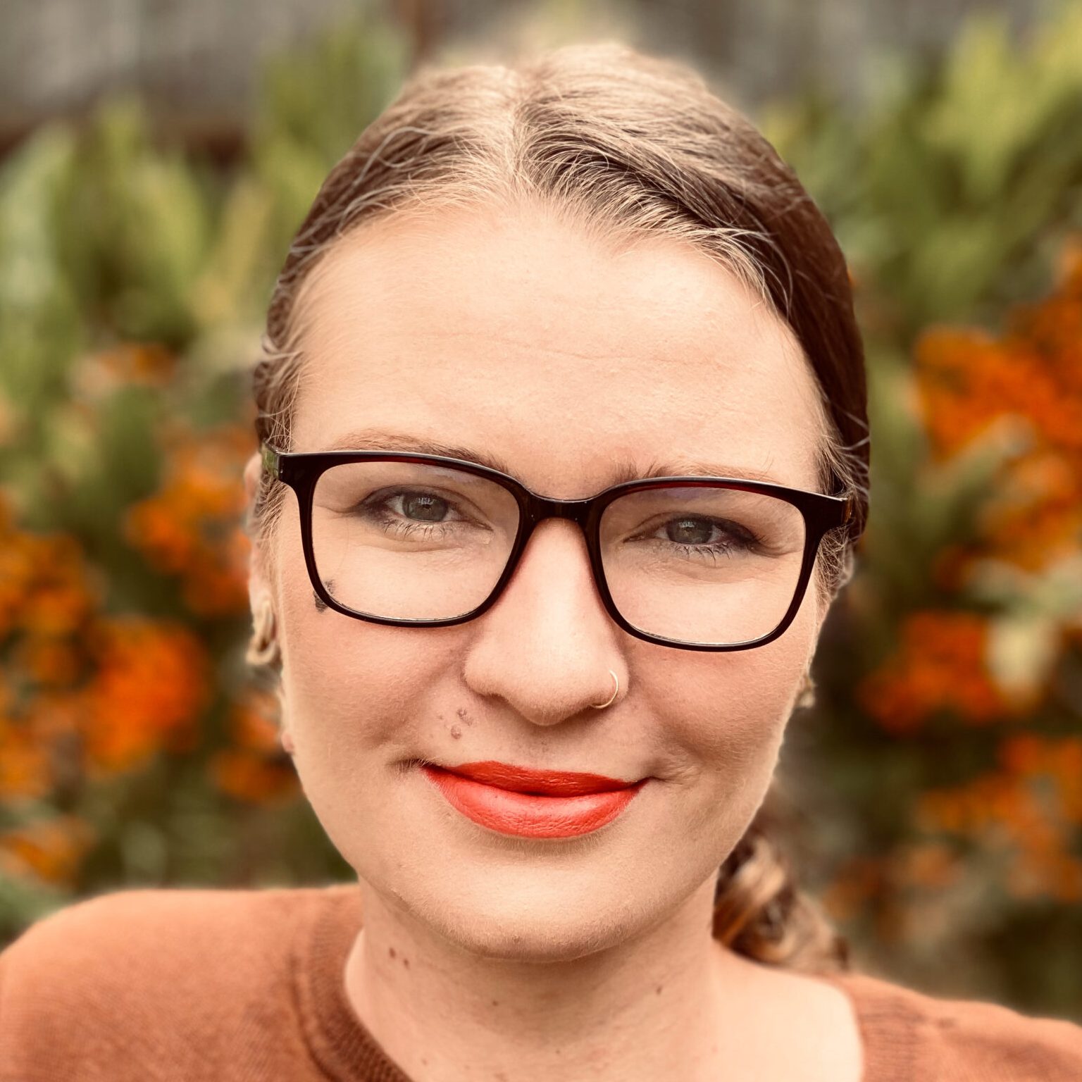 Headshot of Megan Sullivan-Tuba, a white woman with glasses and brown hair pulled back. Individual and couples therapy, LGBTQ+ allied.