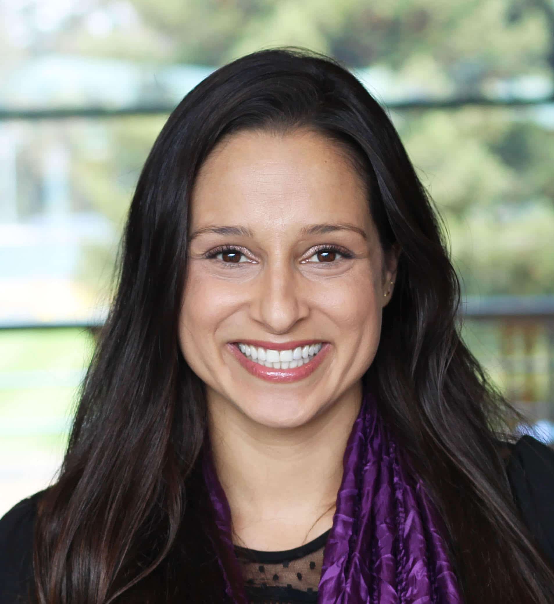 Headshot of San Francisco psychologist Dr. Sahar Dorani, an Iranian American woman with long dark hair and a purple scarf.