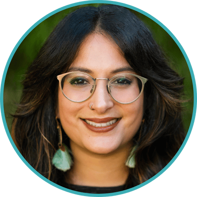 Photo of Dr. Amelia Jayanty, online therapist in California. Amelia is a dark haired, multiracial South Asian psychologist with dark hair, glasses, and dangly earrings.