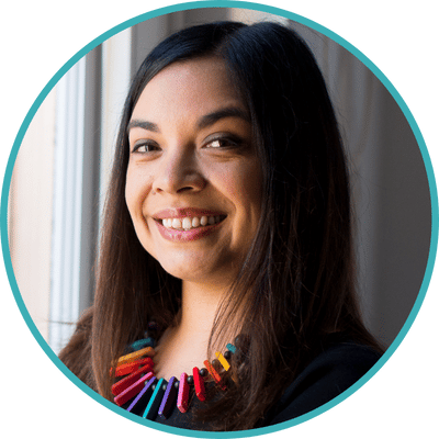 Photo of Dr. Maya Borgueta, clinical psychologist serving San Francisco and Los Angeles. Maya is a multiracial, Filipinx therapist with long dark hair. She is wearing a bright colored necklace and a black top.
