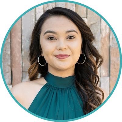 Photo of Los Angeles therapist Dr. Rona Maglian, chronic pain psychologist. Rona is a Filipinx Asian American woman with long wavy hair. She is wearing silver hoop earrings and a turquoise blouse.