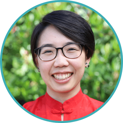 Headshot of San Francisco psychologist Dr. Justine Fan, a trans Asian American person with short hair and glasses in a red blouse.