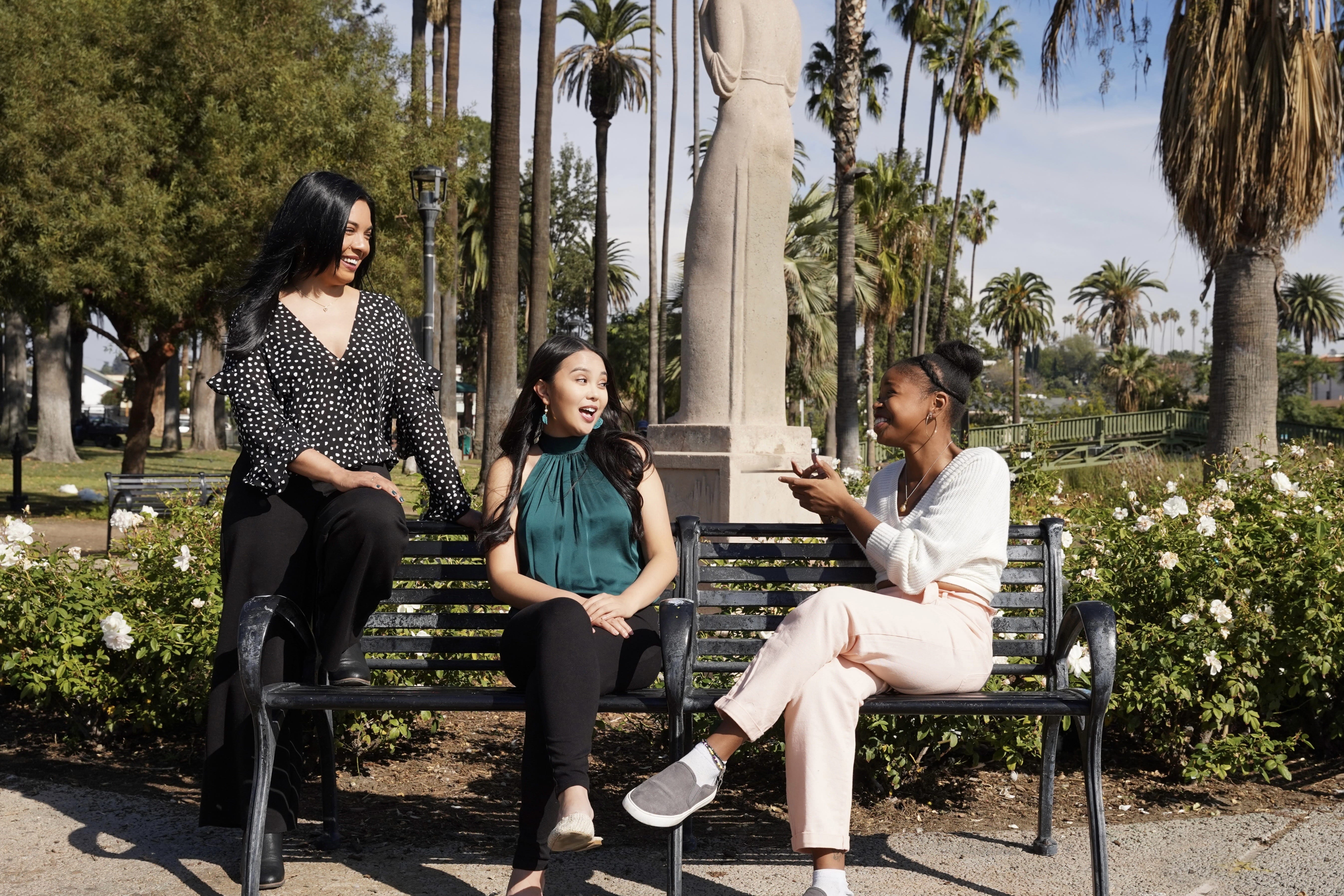 Stella Nova therapists in Los Angeles relaxing together on a bench in Echo Park.