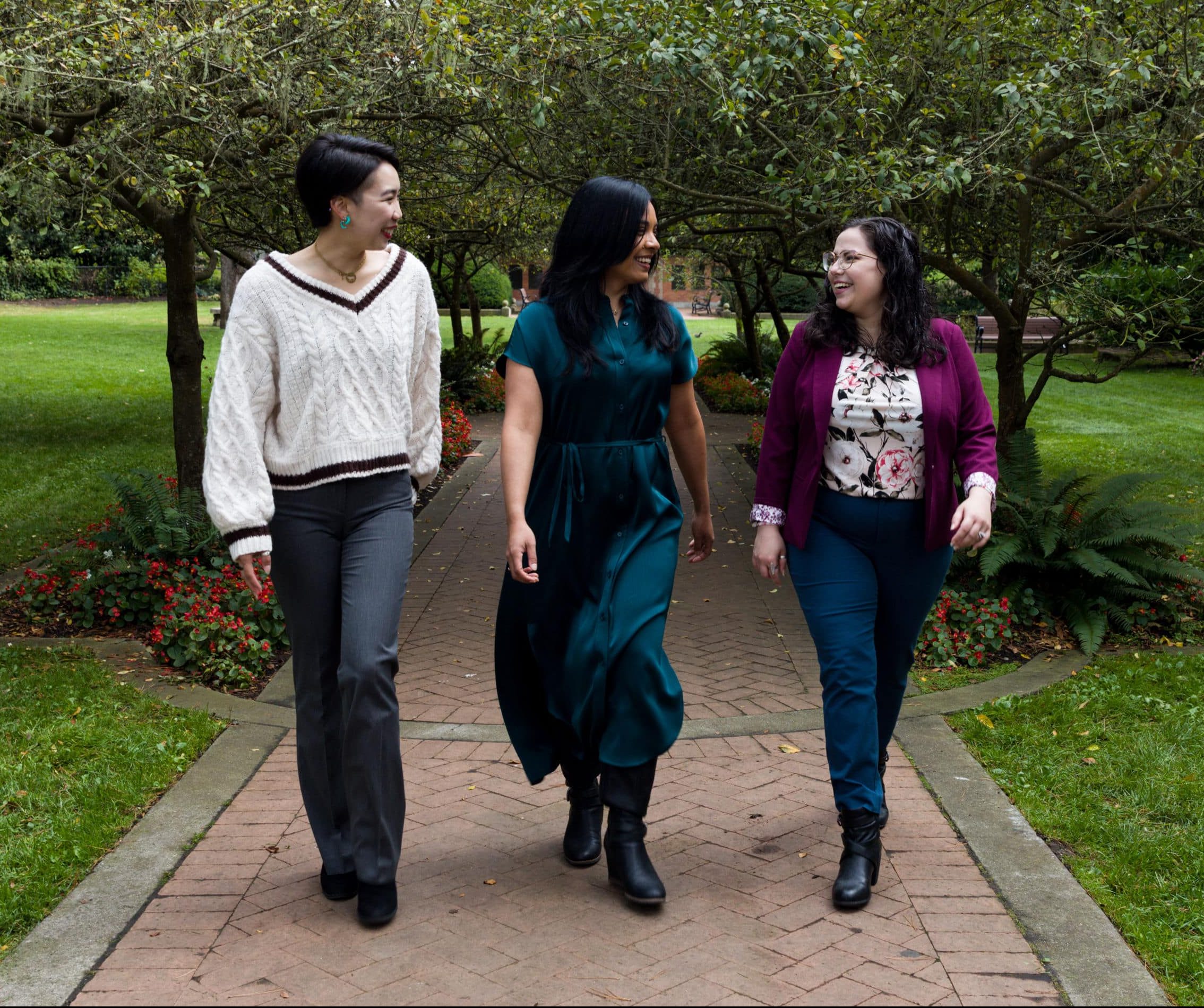 Three Stella Nova therapists walking together outside in Golden Gate Park in San Francisco, appearing to chat with each other.